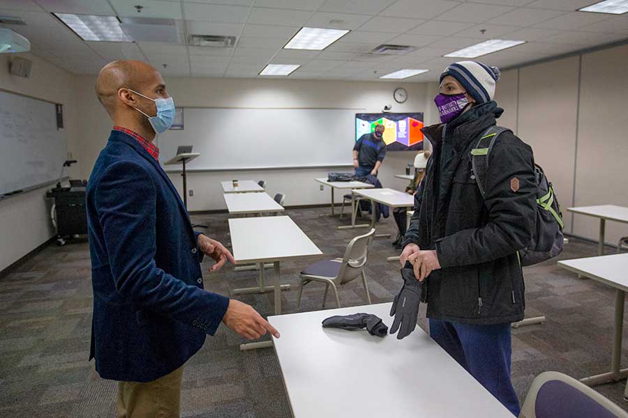 Logan Edwards talks with a student.