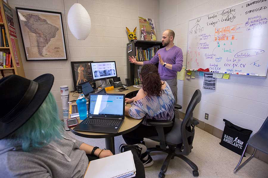 Nate Maddux stands at the front of a classroom.