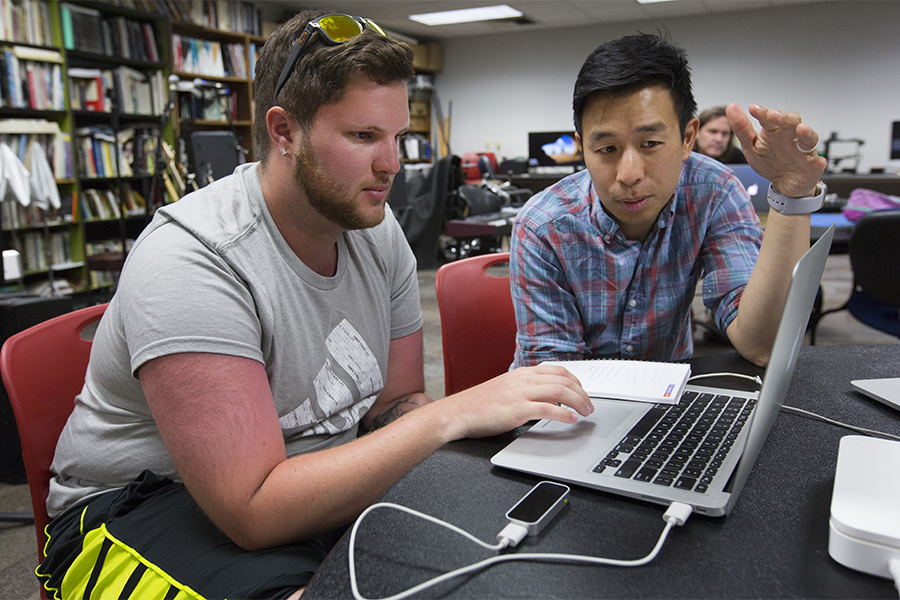 Nick Hwang works with a student.