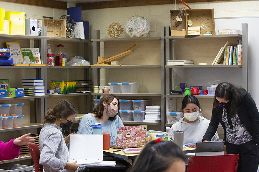 Ozgul Kartal teaches at a table with students.