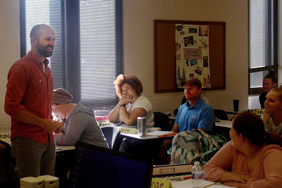 Nate Maddux teaches in a class full of students.