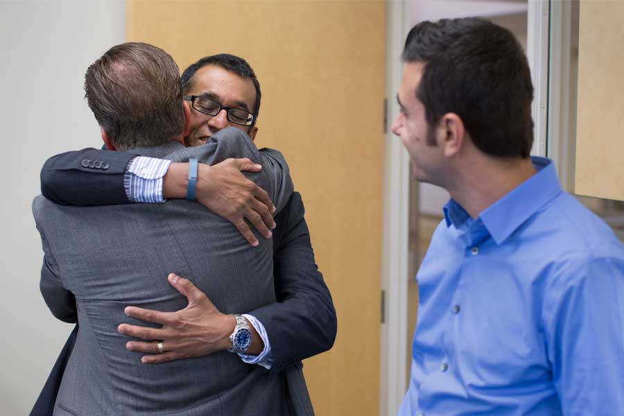 Parboteeah hugs doctoral candidate Stephen Gray.