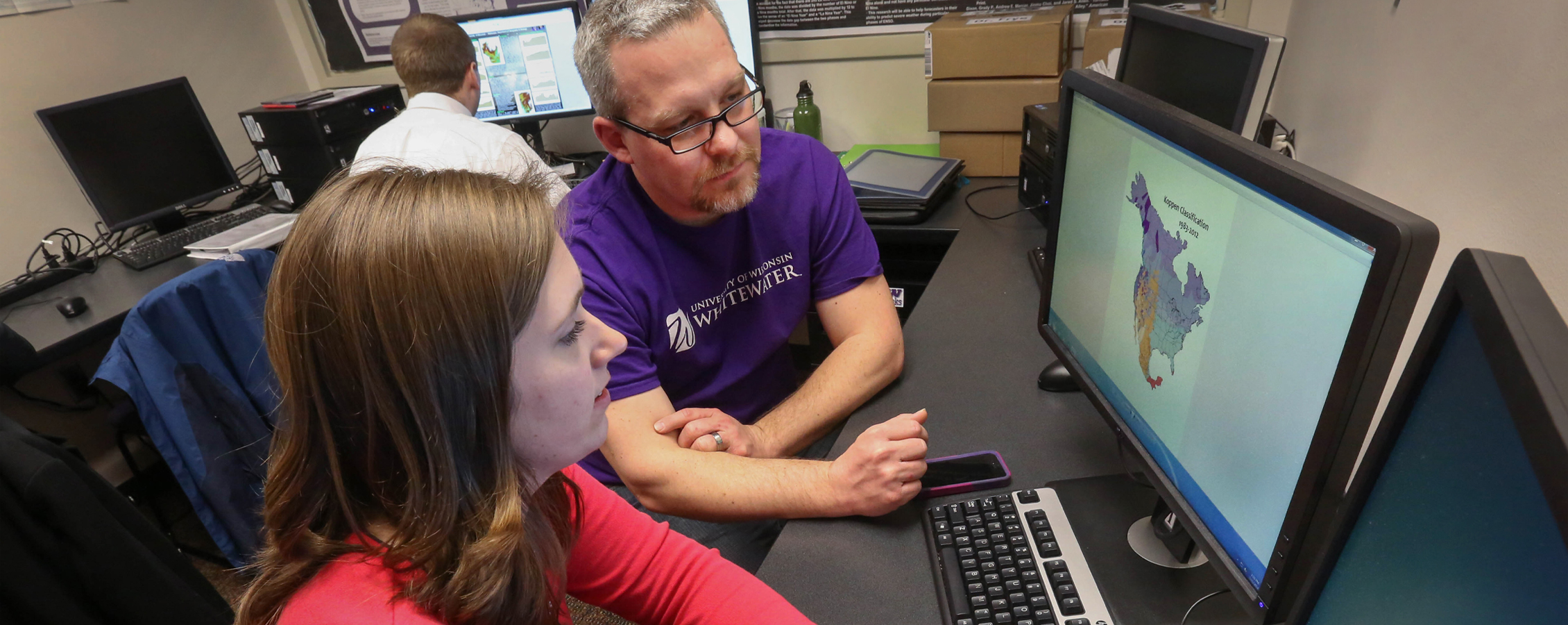 John Frye works with a student at a computer.