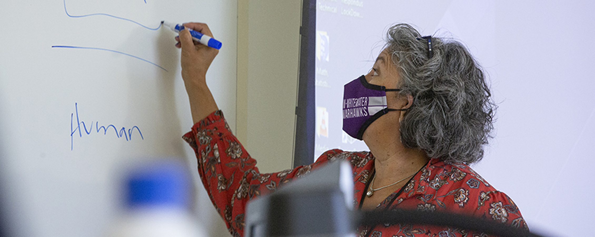 Pilar Melero writes on a whiteboard.