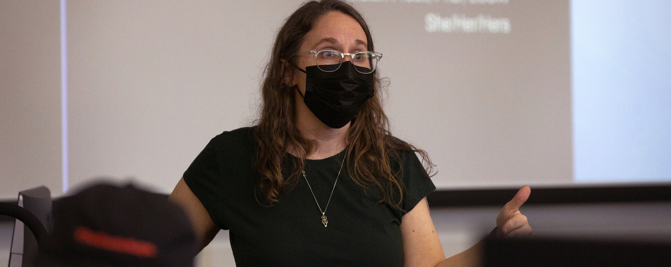 Kristen Prock stands in front of class.