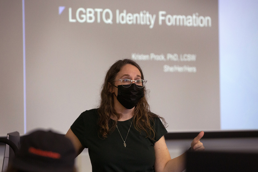 Kristen Prock stands in the front of class.