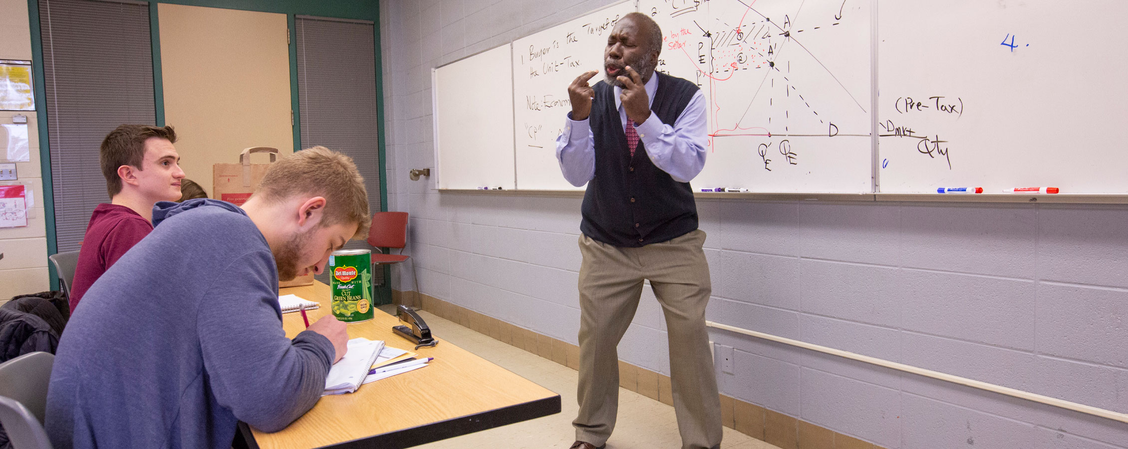 George Jones teaching at a whiteboard.