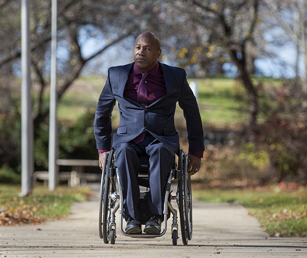 Melvin Juette travels down a paved sidewalk.