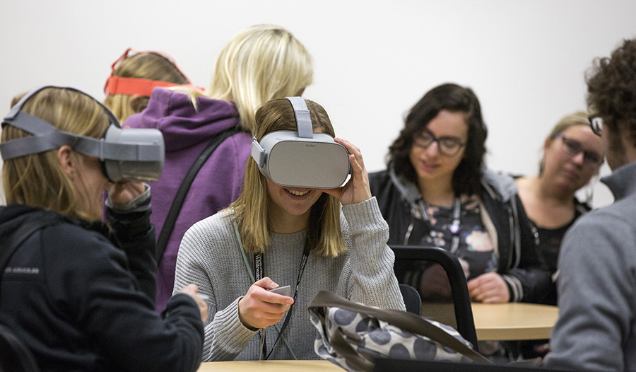 Student wearing virtual reality goggles.