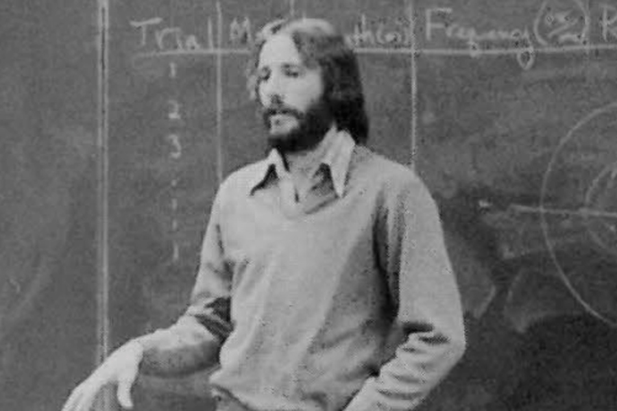 Pat Slane teaching in front of a chalkboard