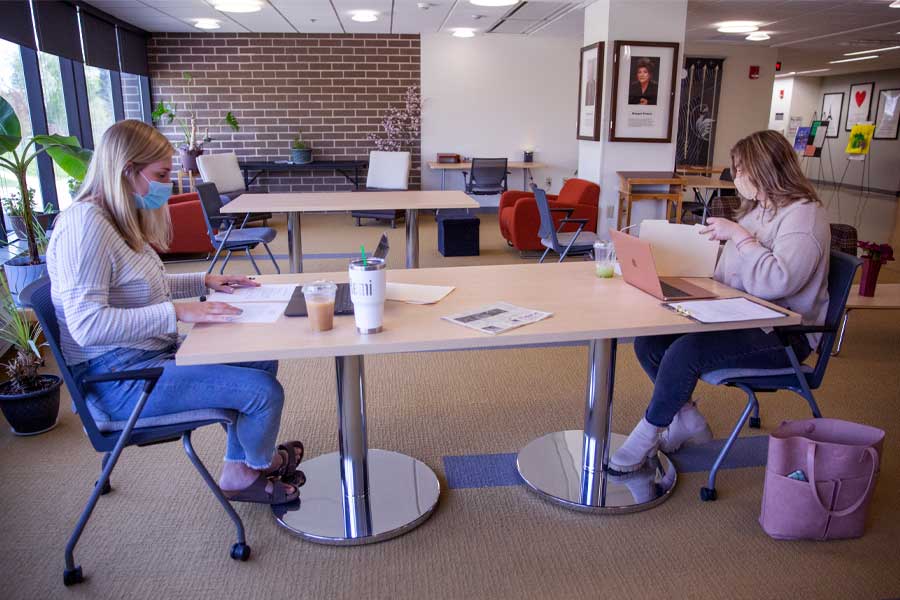 Two people sit at a table.