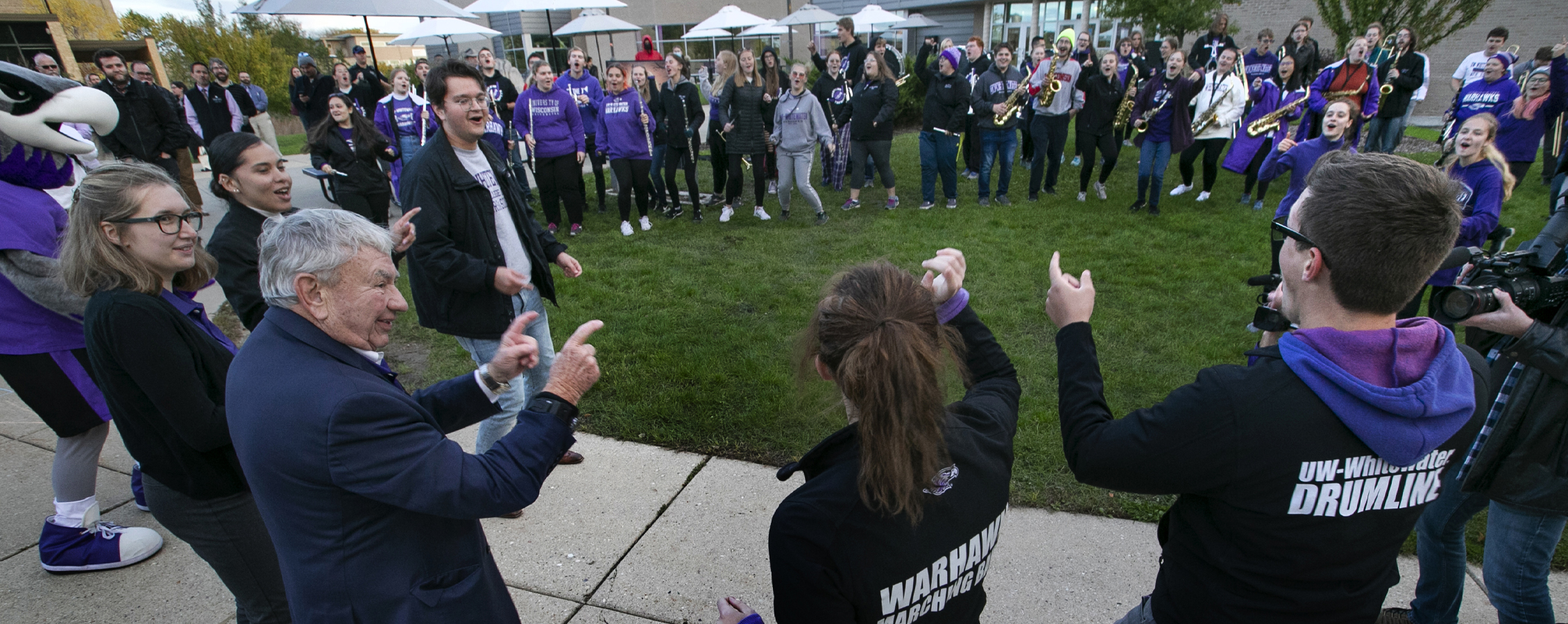 Tommy Thompson learns the Warhawk Strut from the Marching Band.