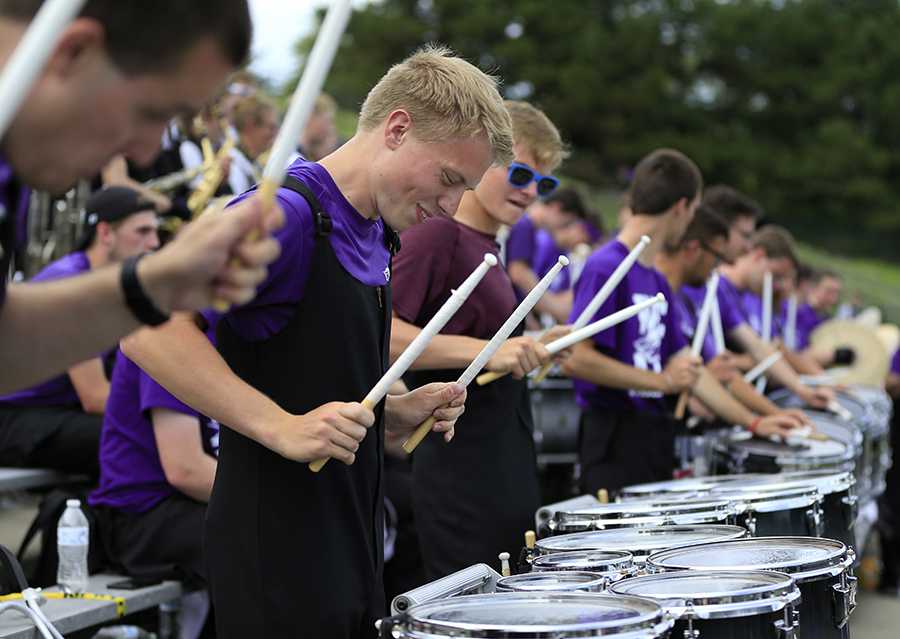 Dawson Babcock and the drum line work in unison in the grandstand.