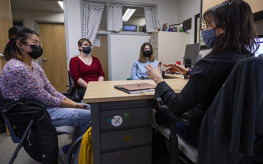 Four people sit around a table.