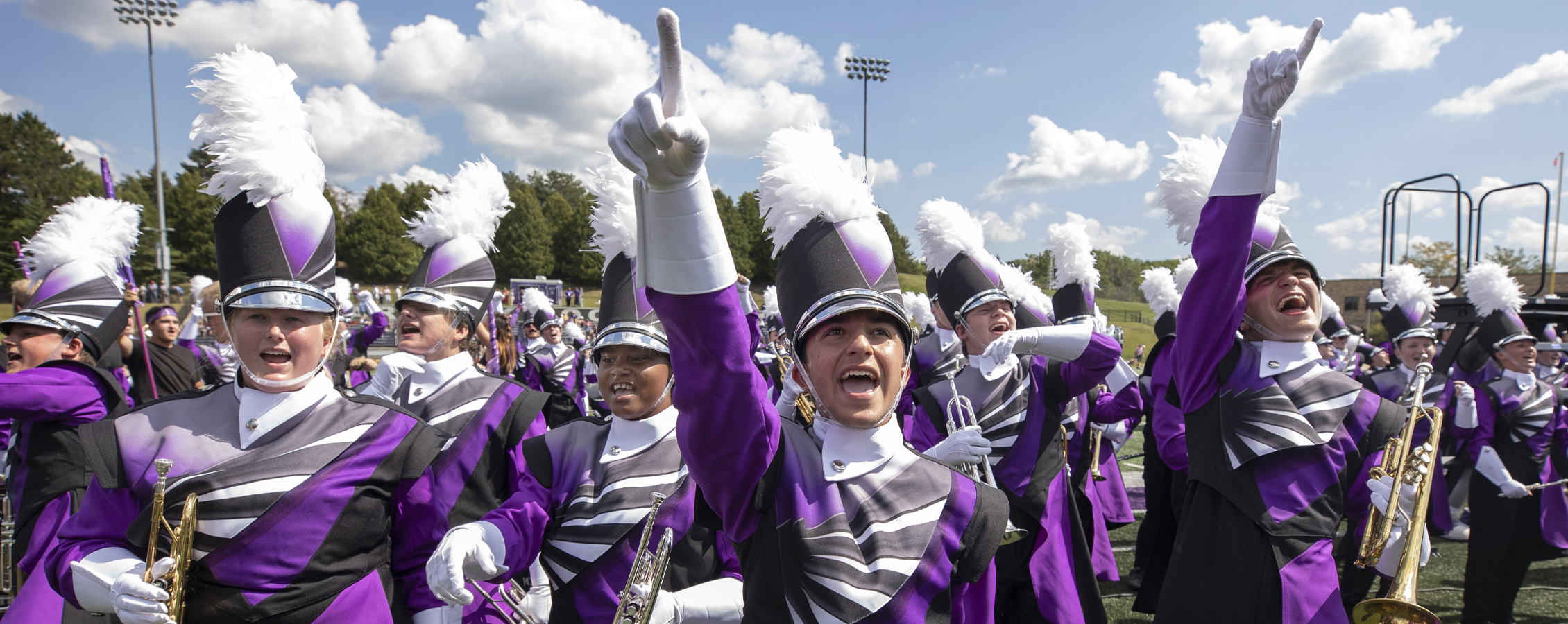 The Marching Band cheers while wearing their new uniforms.