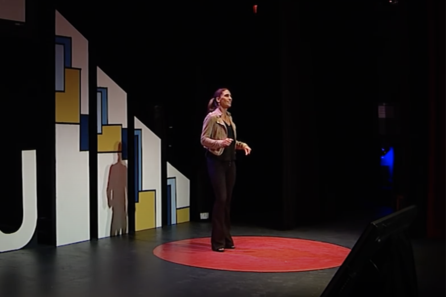 Jen Rulon is on stage giving a TEDx talk.
