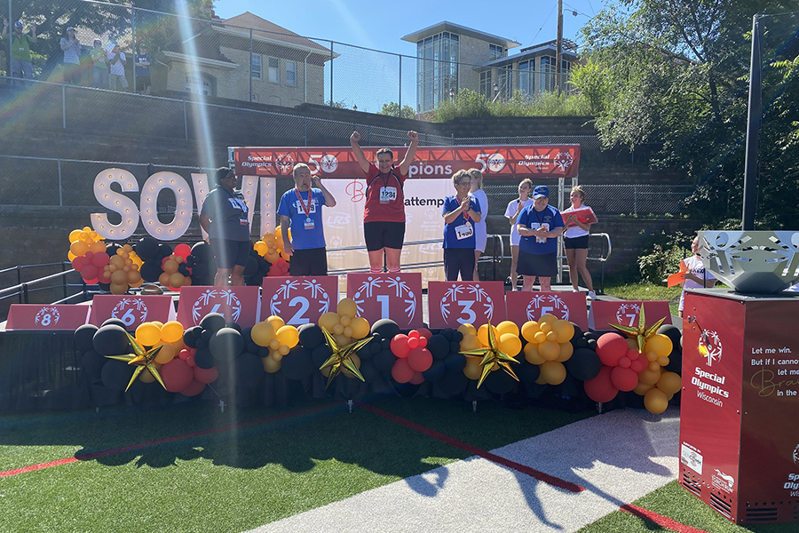 Special Olympics participants celebrate on the winners podium.