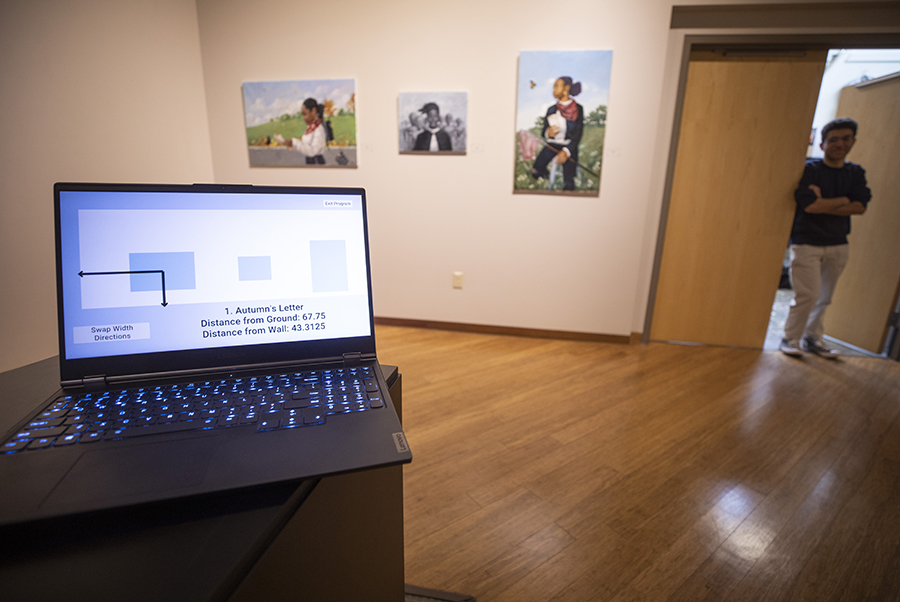 Brian Michael, in the doorway, created art installation software called Primis so he can determine the correct placement and spacing for art in Roberta’s Art Gallery.