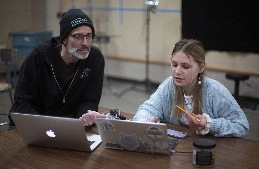 Peterson sits with a faculty member.