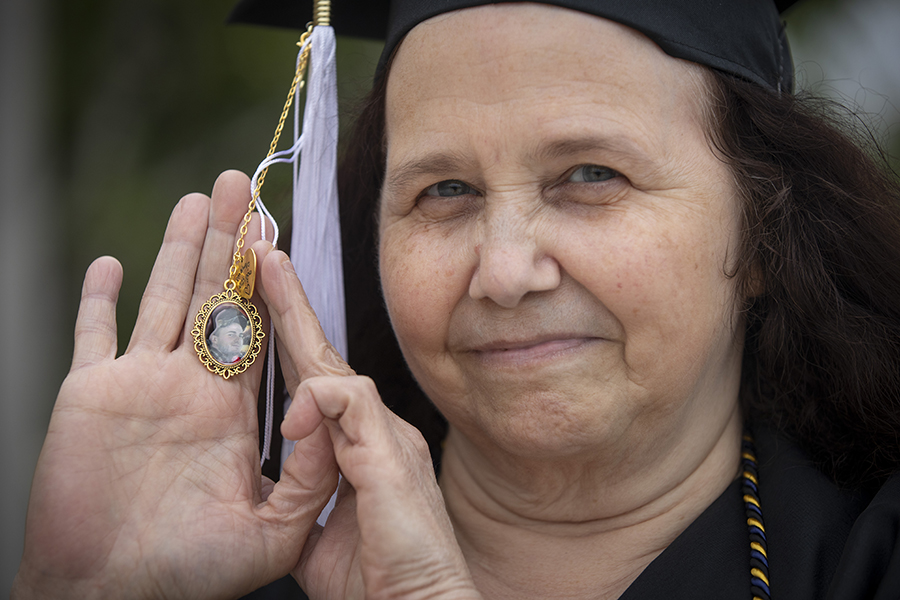 Amy Moore distributes cords at graduation.