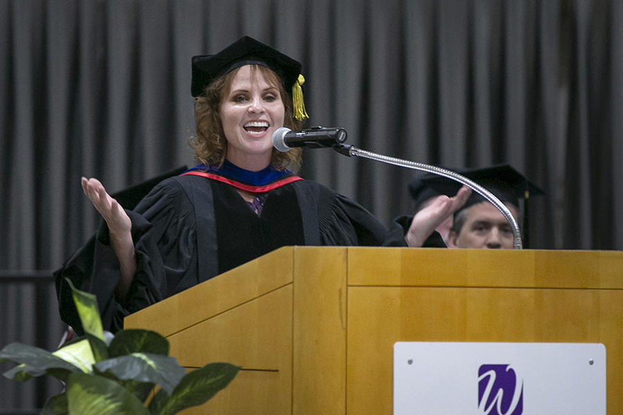 Dean Tricia Clasen speaks at the podium during graduation.