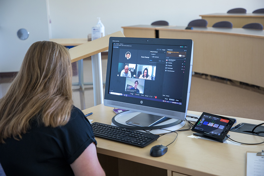 A woman sits in front of a computer.
