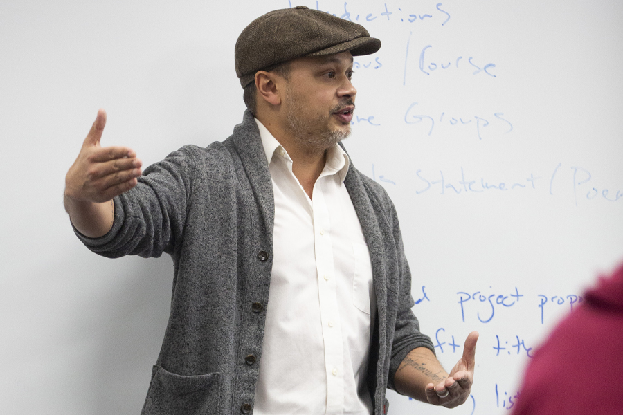 Nick Gulig teaches in front of a whiteboard.