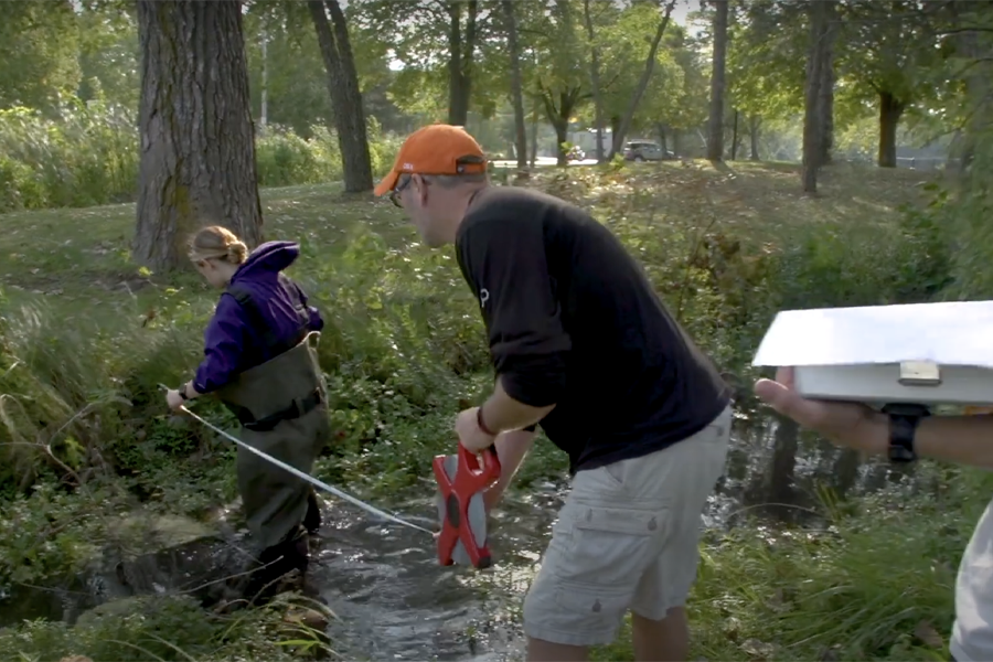 Students work in a river.