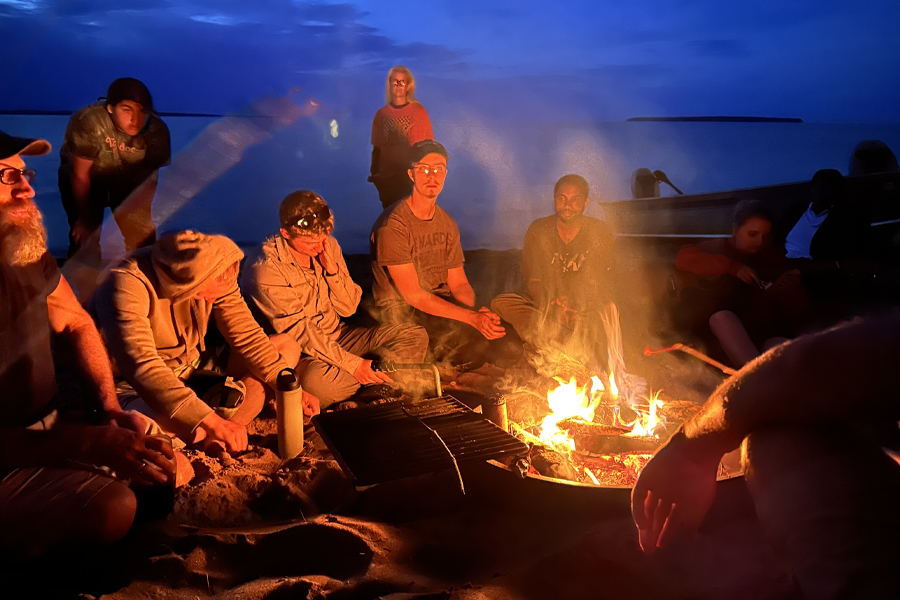 Students surrounding a bonfire.