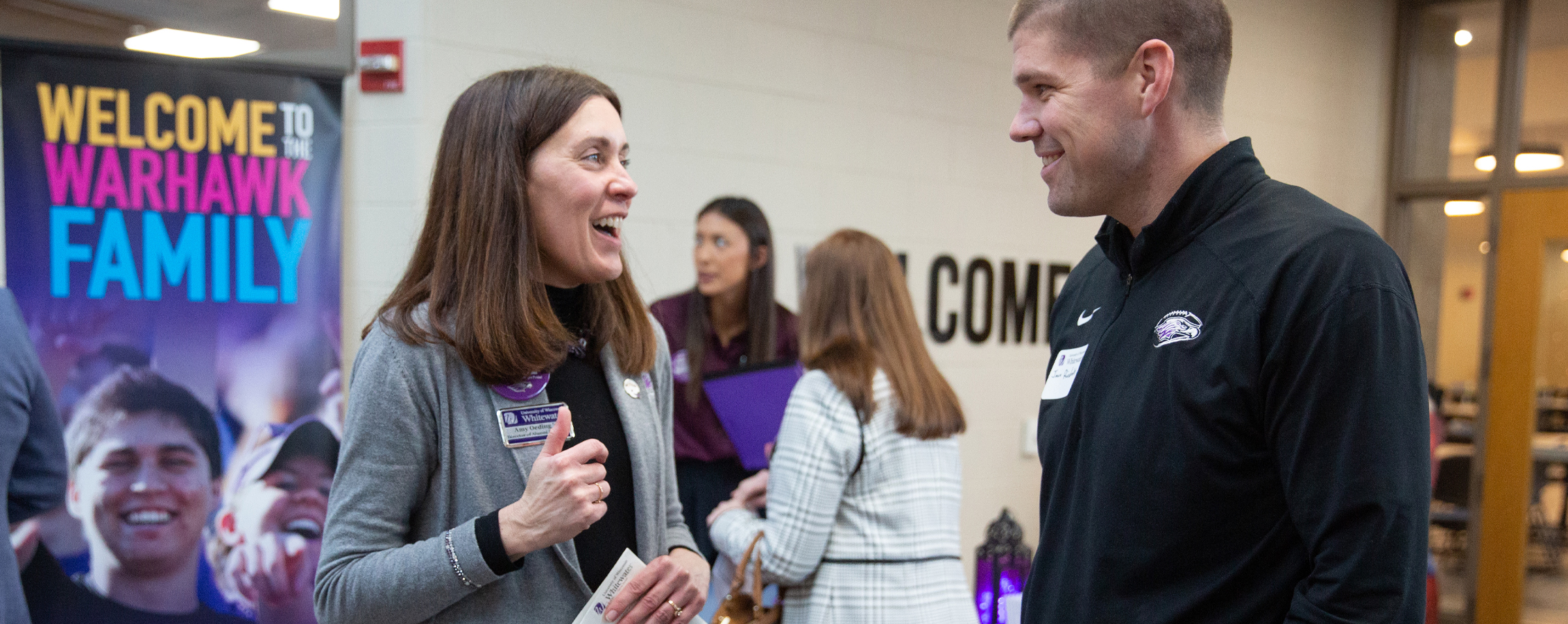 Amy Oeding talks with Warhawk Football head coach Jace Rindahl.