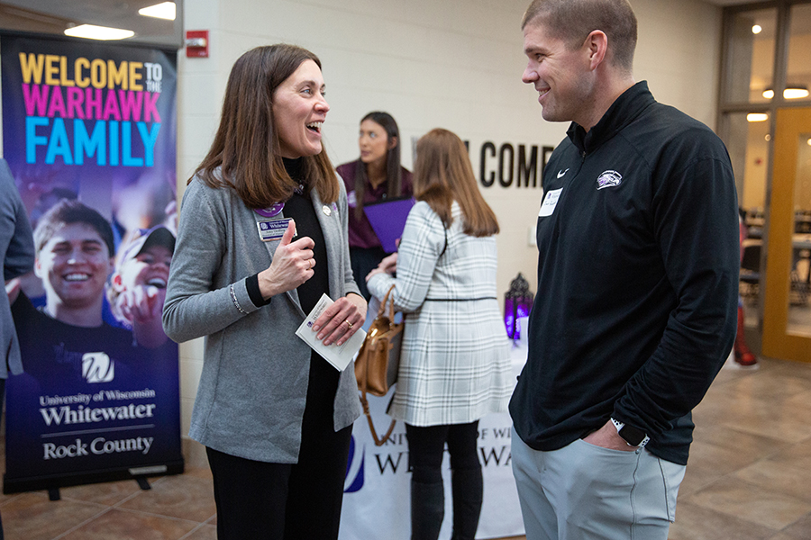 Amy speaking with another individual at an event.