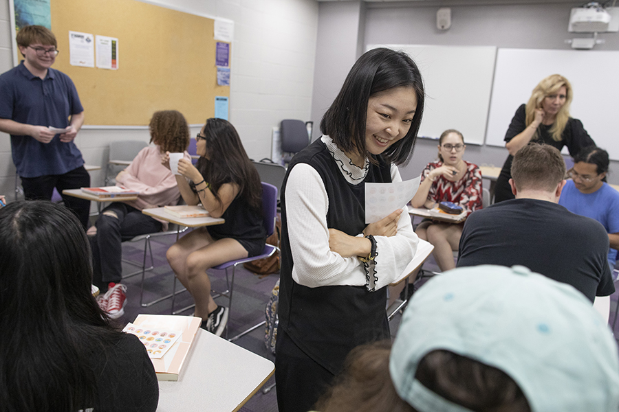 People converse in a classroom.