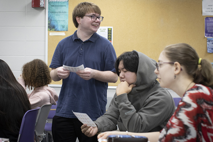 Nicholas Swiatowy stands in a classroom, smiling.