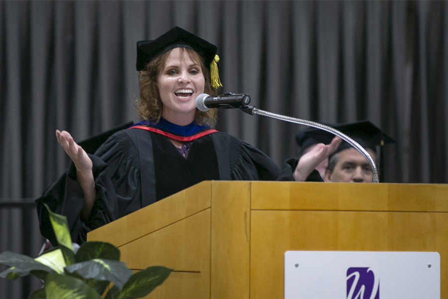 Dean Clasen speaks at the podium during graduation.