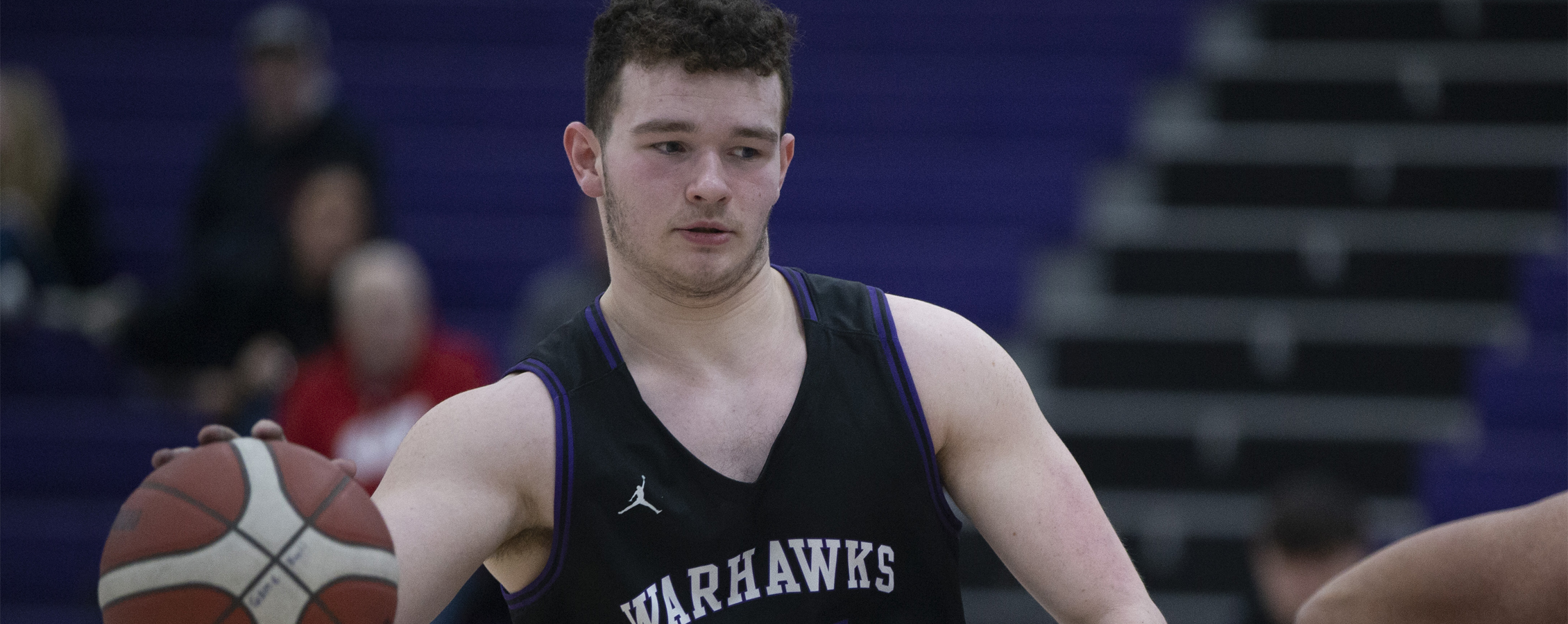 Warhawk AJ Fitzpatrick dribbles the ball.