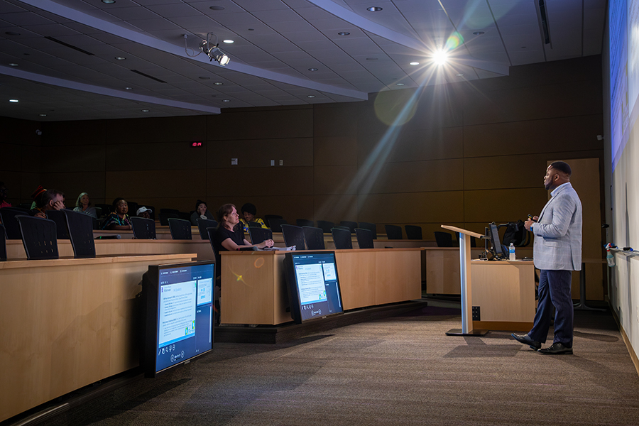 Patrice Achu defends his dissertation in front of a crowd.