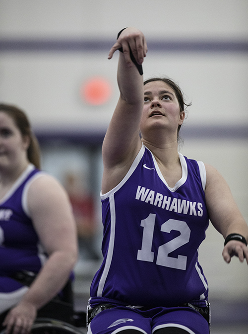A Warhawk wheelchair basketball athlete takes a shot.