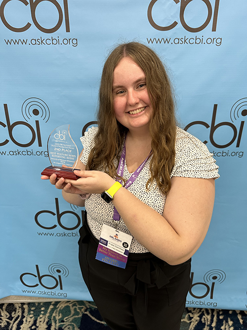 Carchesi smiles with her award in her hands.