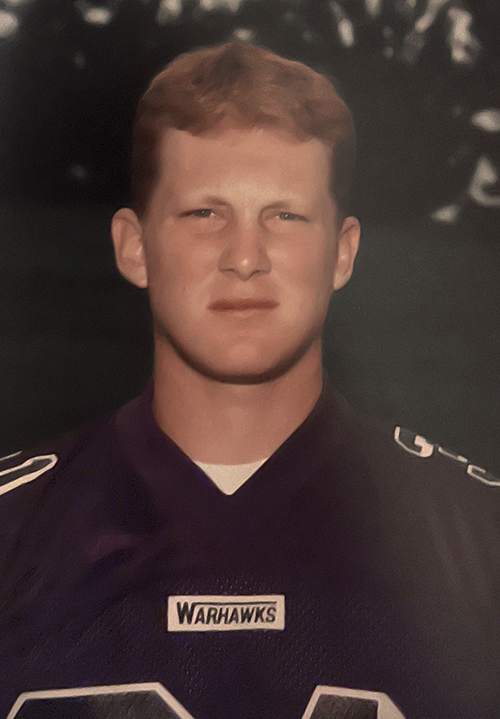 Headshot of Andy Farley in college wearing a Warhawks jersey.