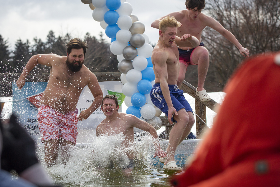 Sigma Tau Gamma fraternity members jump into a cold pool.