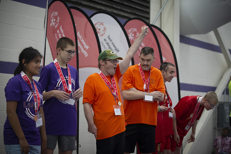 Athletes stand on a platform to recieve their medals.