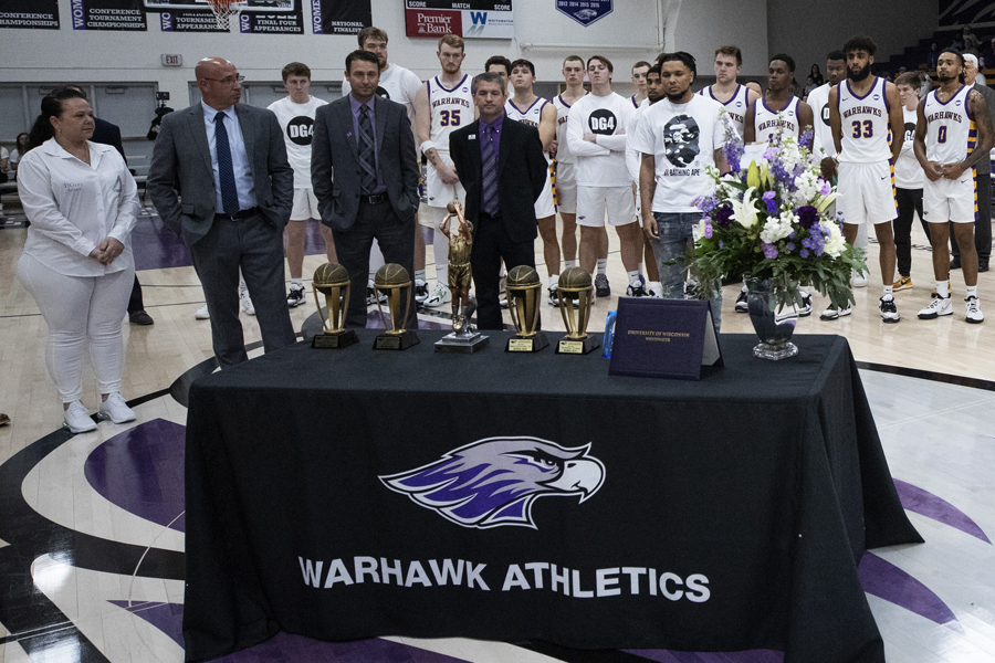 The men's basketball team line up in the gym to honor Derek Gray.