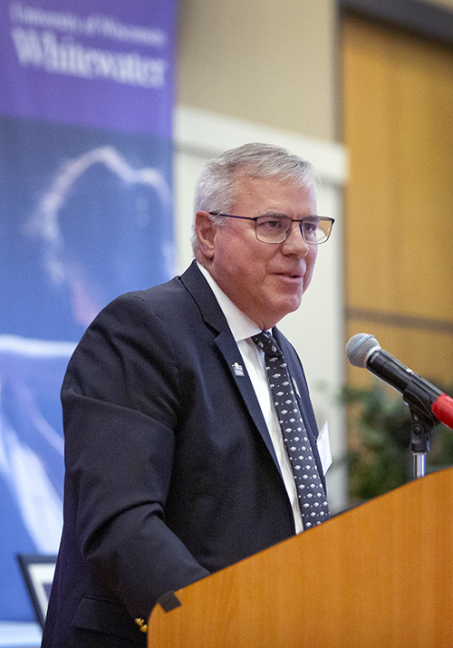 Timothy Hyland speaks at a podium.