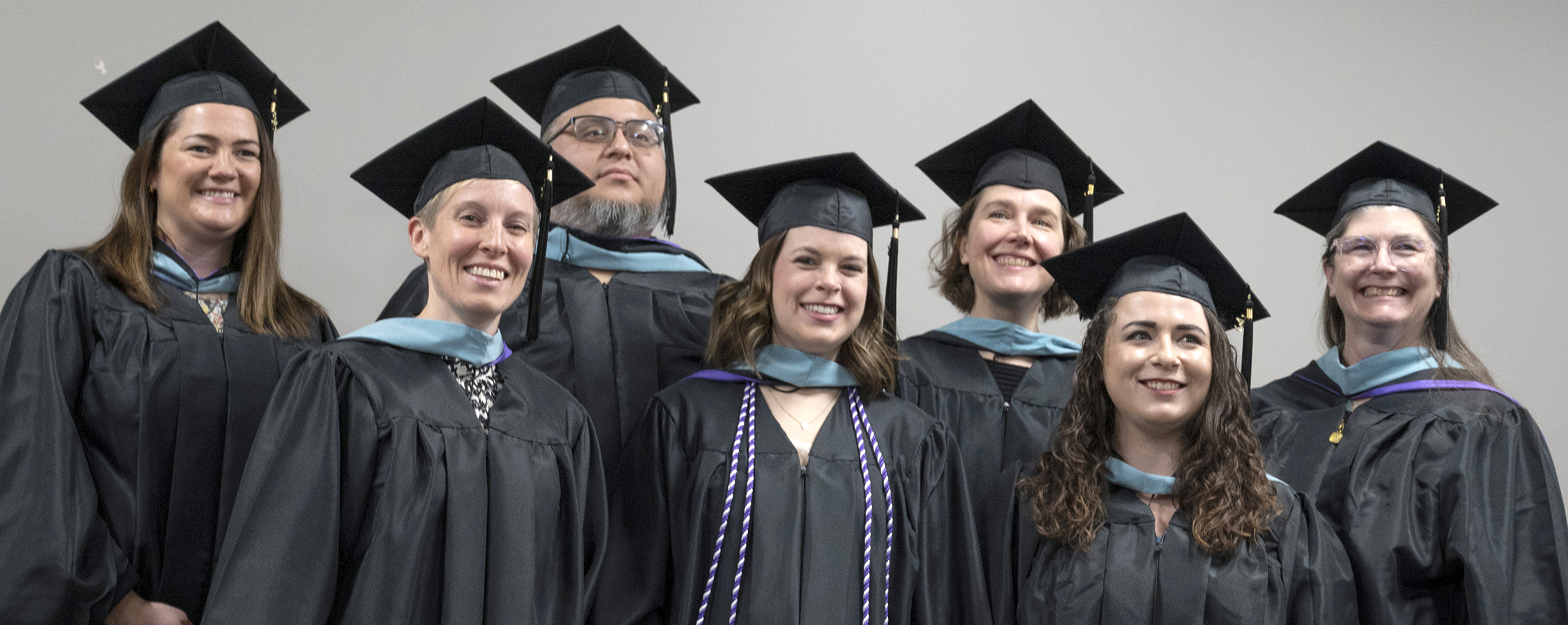 A group of students pose together in their academic regalia.