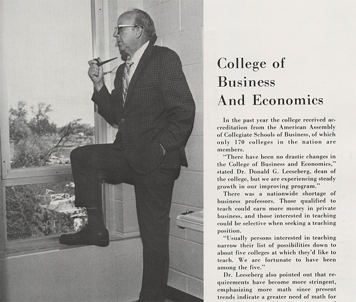 An old newspaper article with a picture of a man standing and holding a pipe.