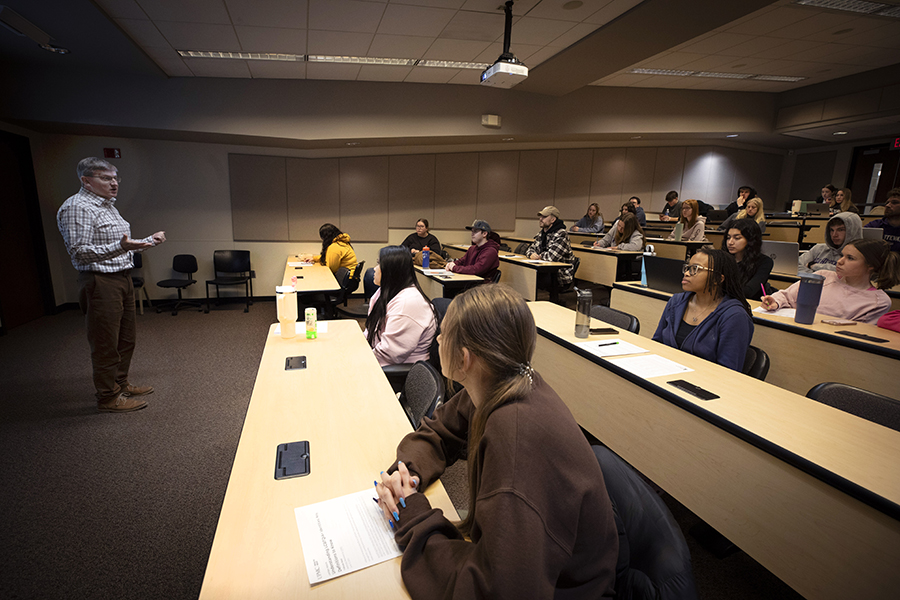 Rowand Robinson talking to a room full of students.