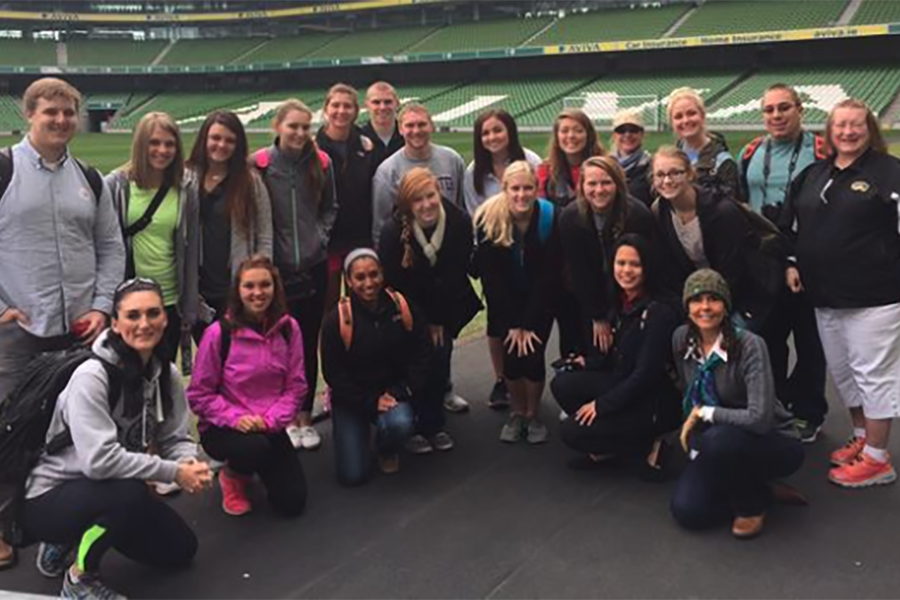 Members from the track and field team gather together and smile for the camera.