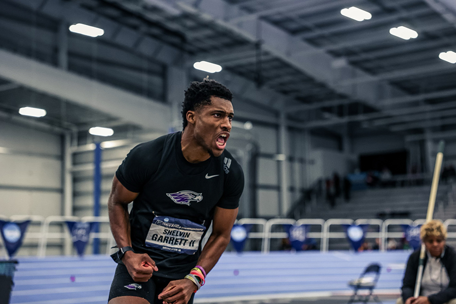 Shelvin Garett, wearing a Warhawk t-shirt, pumps his arms in excitement in the fieldhouse.