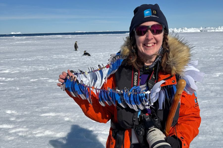 Lisa Werner shows off the necklace made of images of her students in Antarctica.