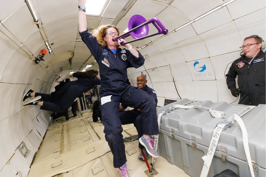 Lisa Warner is floating inside NASA aircraft.